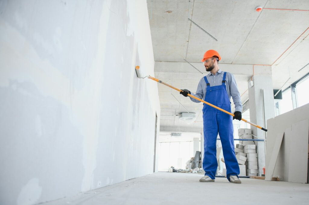 painter man painting the wall, with paint roller